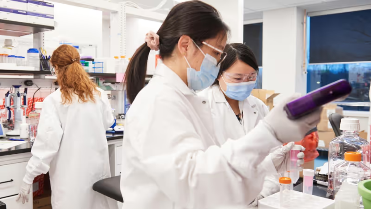 Scientists in a lab using automated tools for AI-driven mRNA research