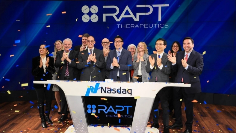 Biotech executives mark a major corporate milestone during a Nasdaq ceremony