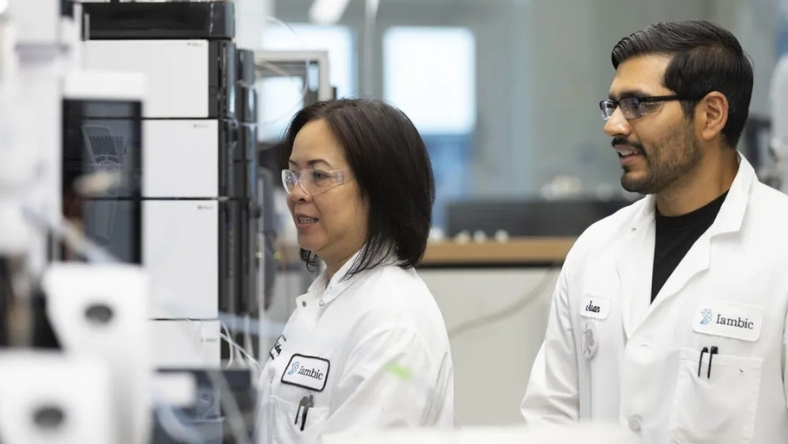 Scientists working with laboratory instruments in biotech lab